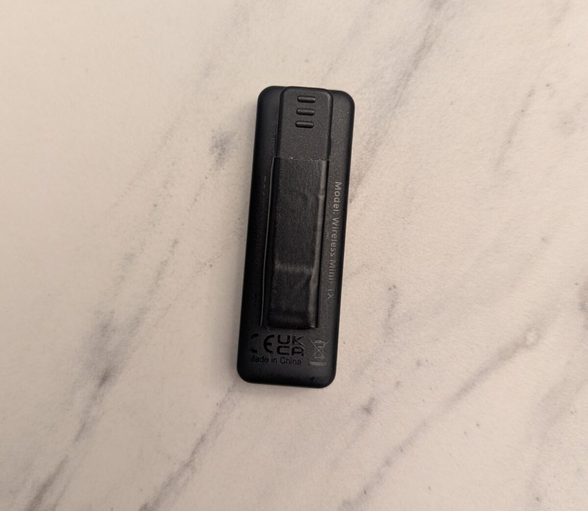 Movo mic with black electrical tape wrapped around the clips.